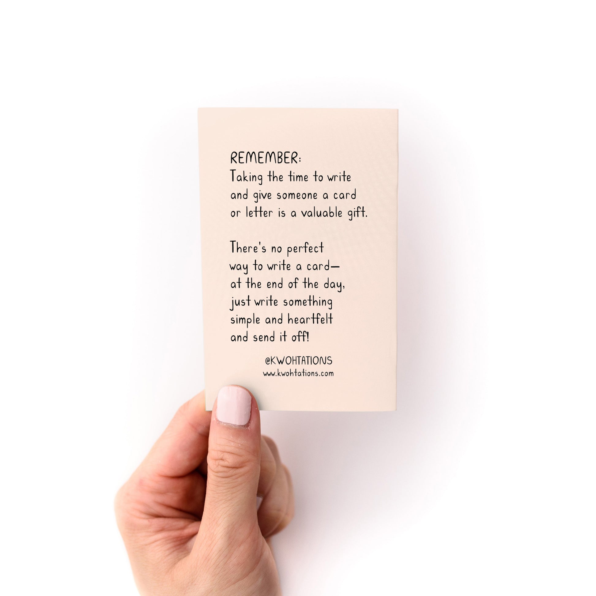 Hand holding a card with a message about writing cards for the product What to Write in Any Card Zine.