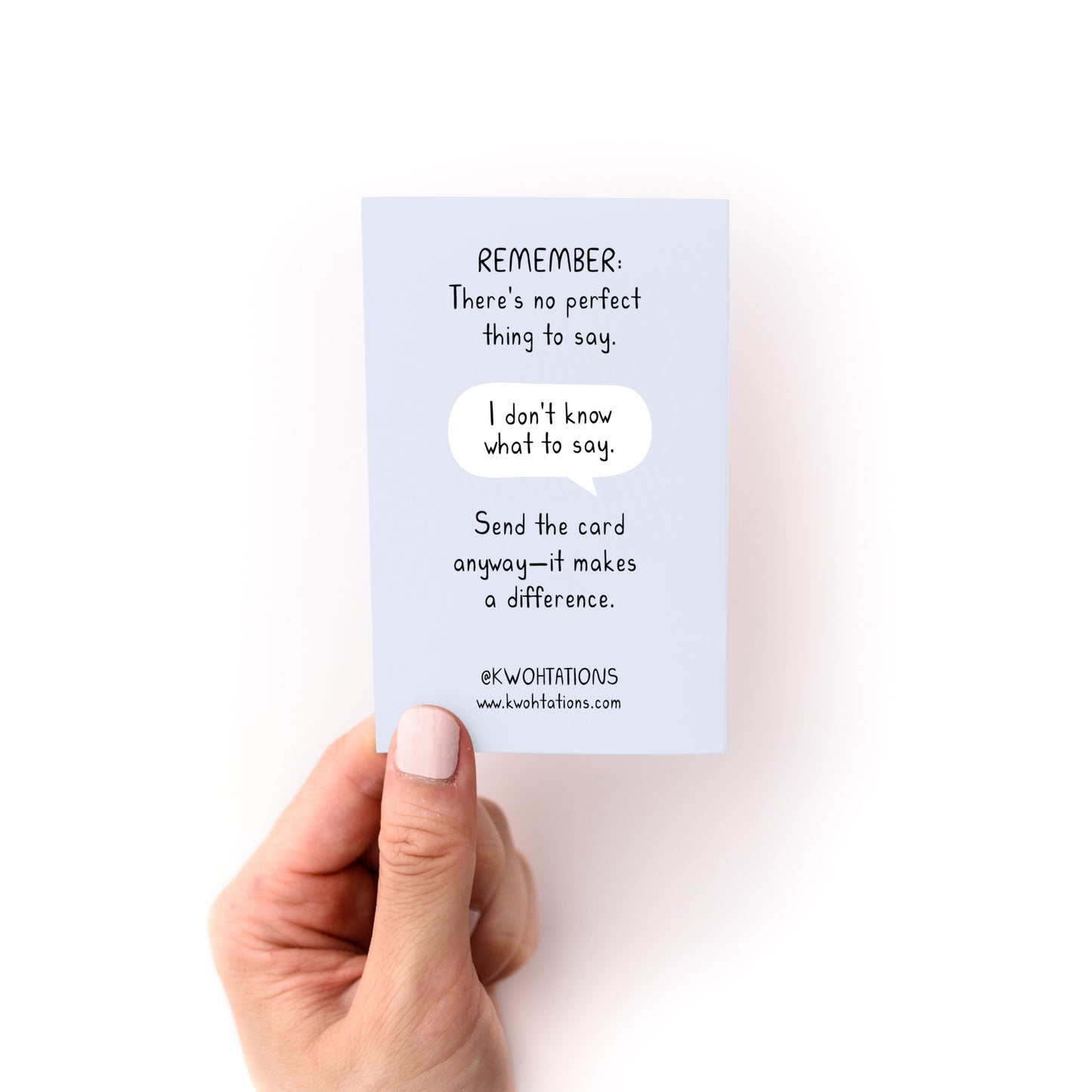 Hand holding a card with sympathy message from What to Write in a Condolence Card Zine by Kwohtations.