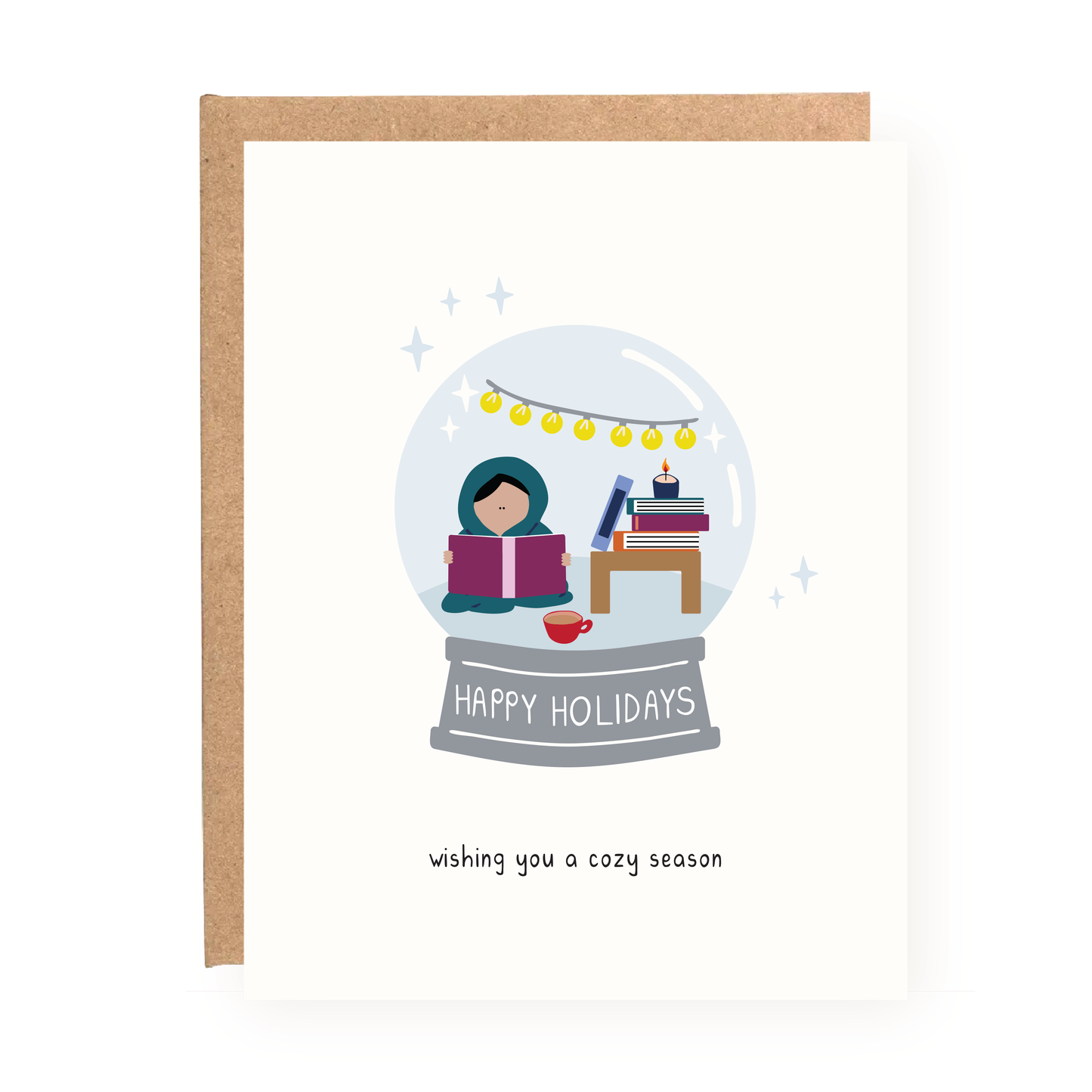 Cozy Snowglobe Holiday Card showing a person reading inside a snowglobe with books and holiday lights.