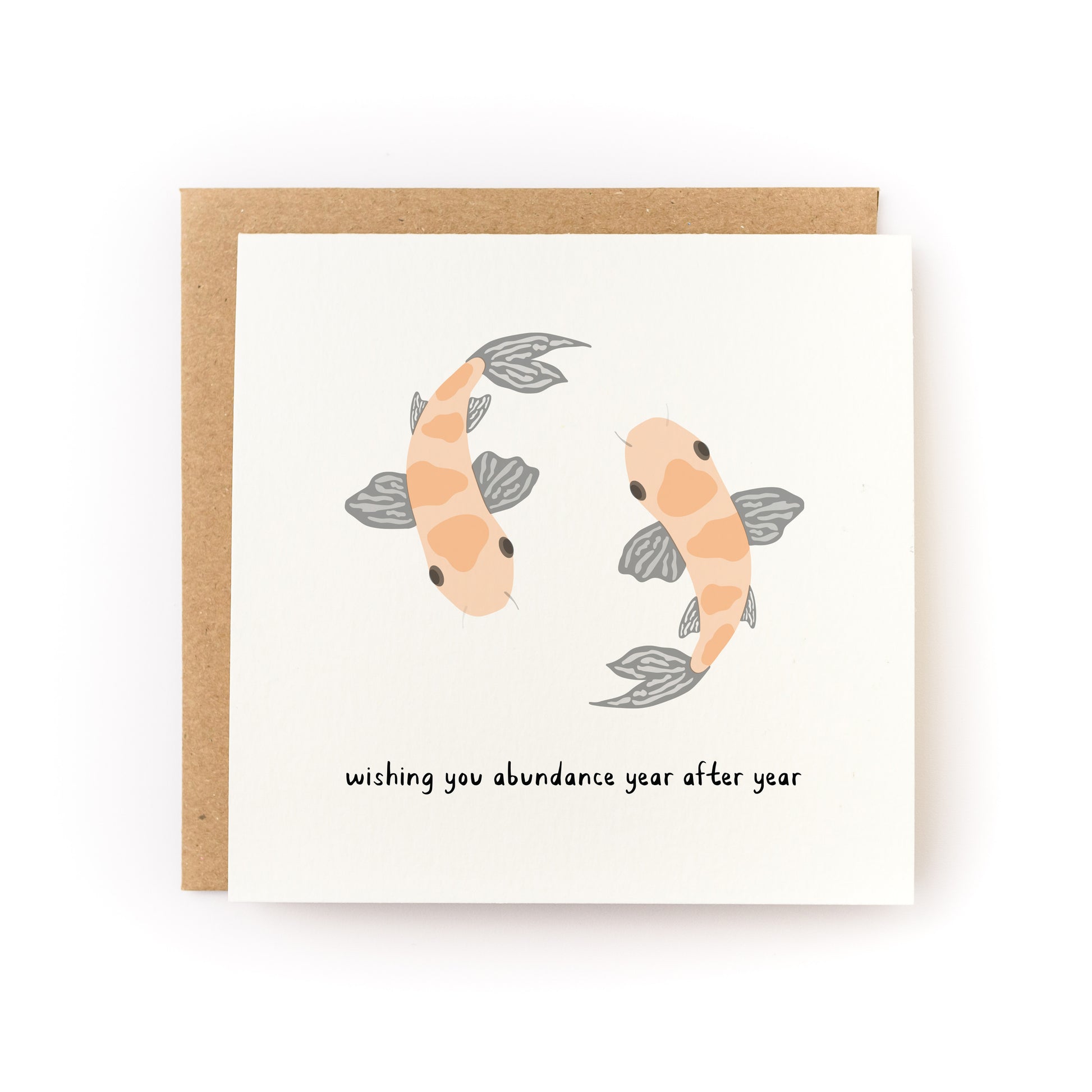 Koi Fish Lunar New Year Letterpress Card with two koi fish and "wishing you abundance year after year" text.
