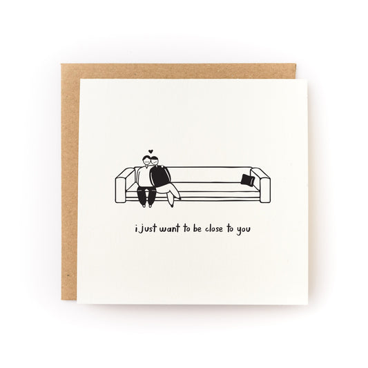 Close to You Letterpress Card with a black and white illustration of a couple sitting close on a couch and text below.