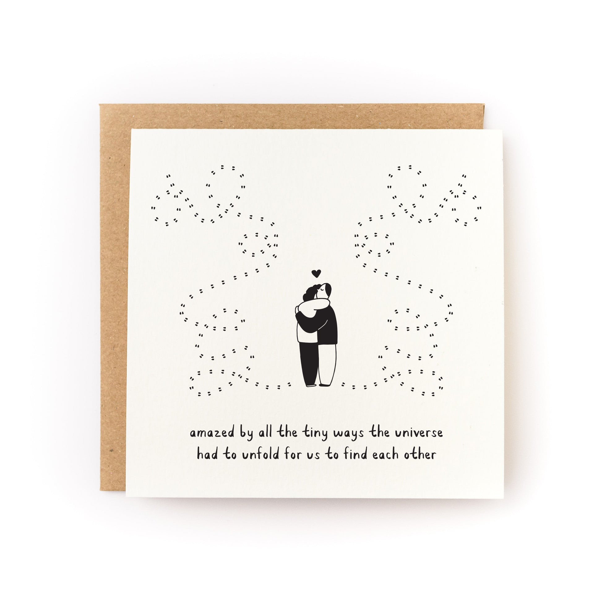 Universe Unfolds Letterpress Card showing a couple hugging with a starry universe design on white folded cardstock
