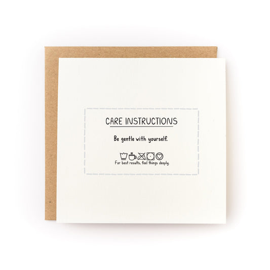 Care Instructions Letterpress Card reading Be gentle with yourself with brown kraft envelope on white background