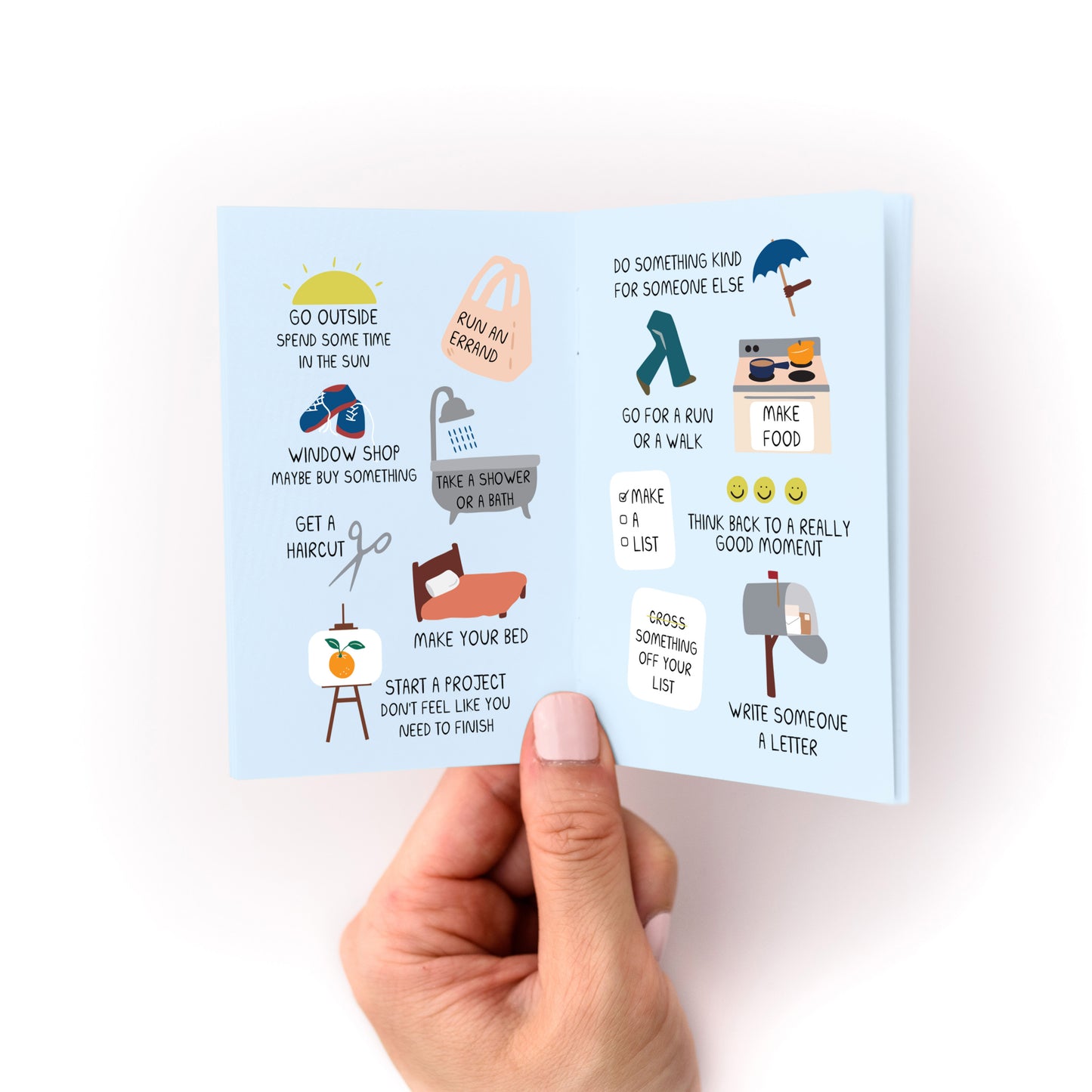 Things to Do When You're in a Depressive Spiral Zine open to activity list pages held in hand.