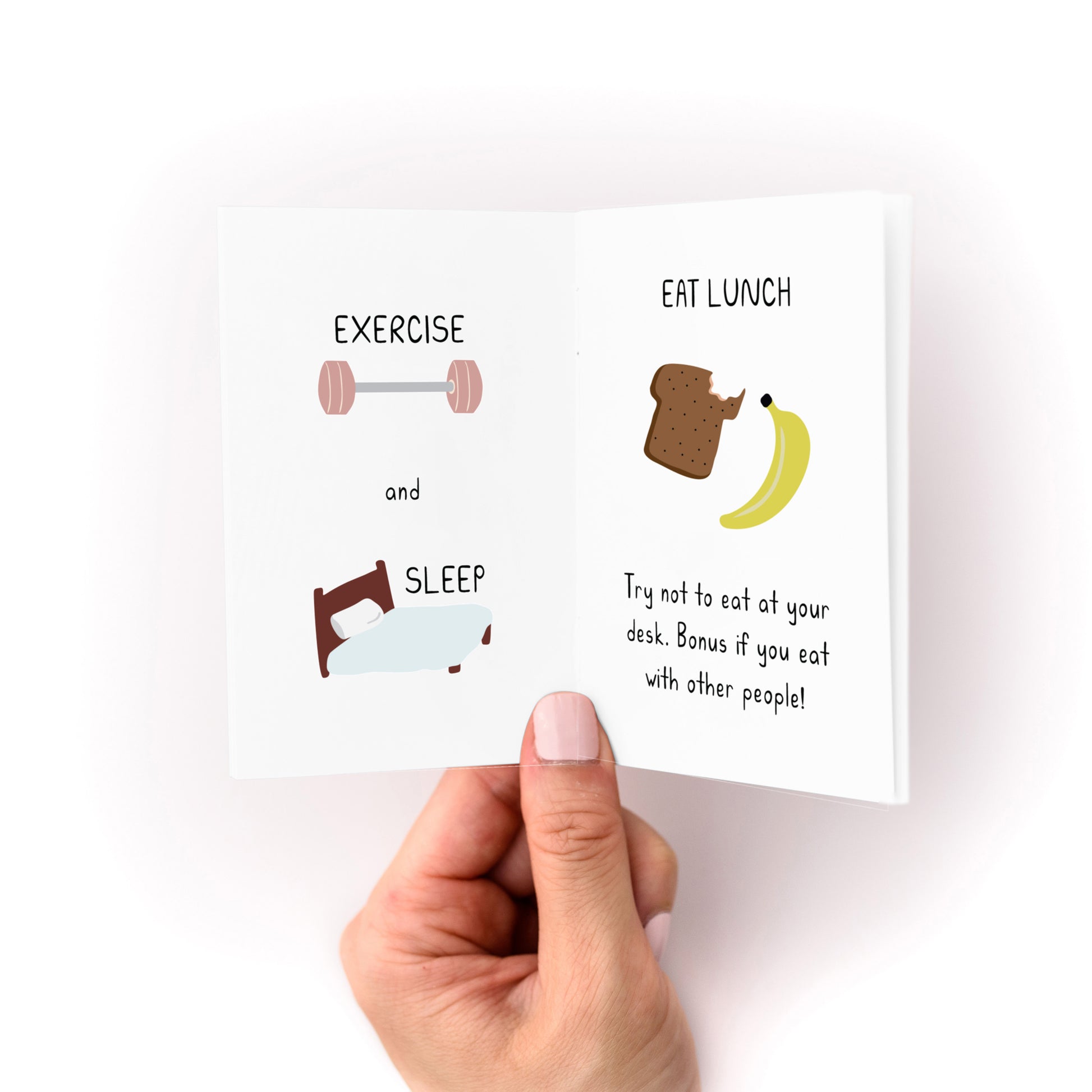 Hand holding open the Working is Hard Zine showing pages with exercise, sleep, and lunch reminders.