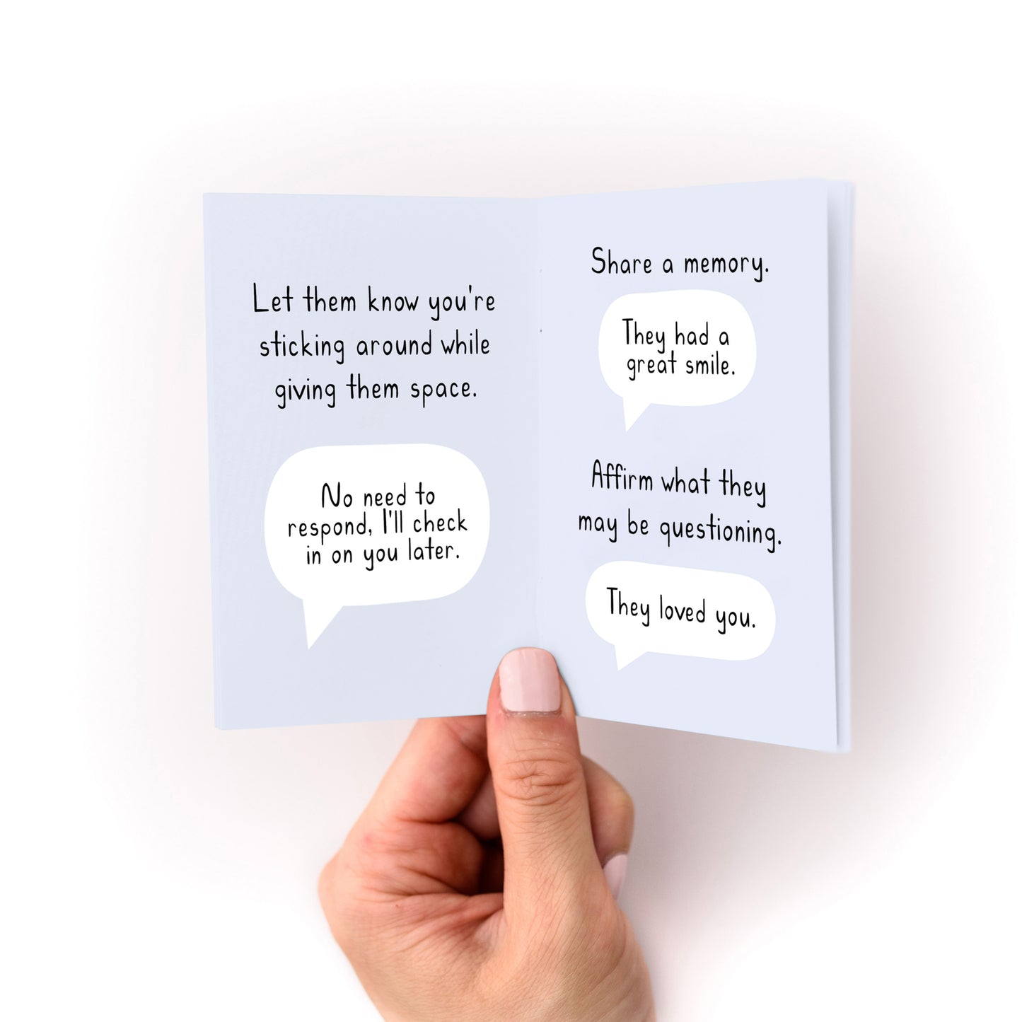 Hand holding open What to Write in a Condolence Card Zine showing thoughtful sympathy message examples.