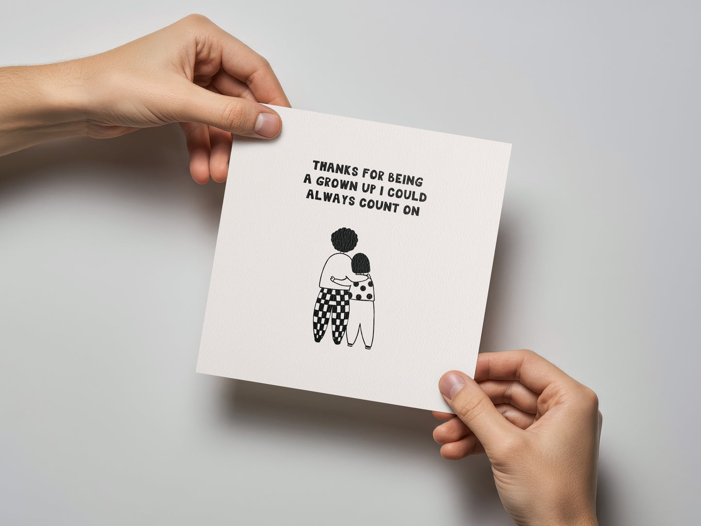 Square Mother's Day card with black text and minimal illustration of two people hugging on white background