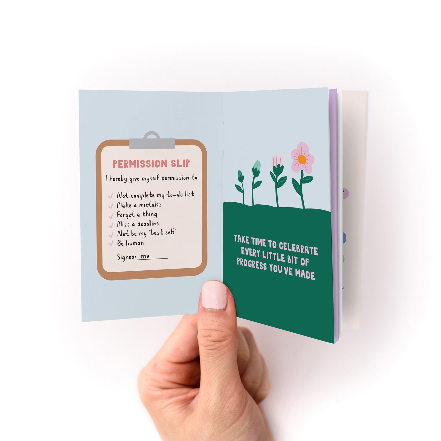 Hand holding open Reminders for Uncertain Times Zine showing permission slip and illustrated flowers with motivational text.