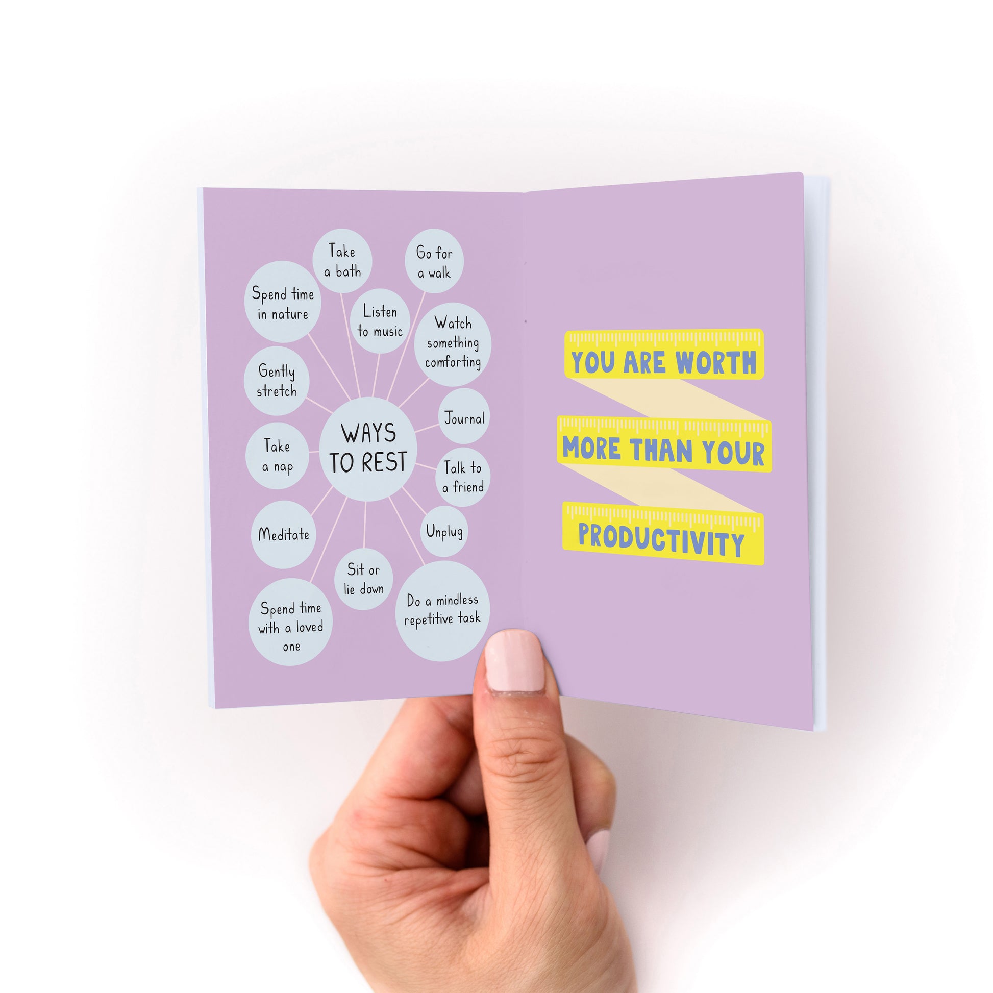 Reminders for Uncertain Times Zine showing self-care tips and affirmation on a lavender background with hand holding it