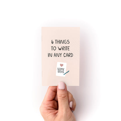 Hand holding "What to Write in Any Card Zine" showing card titled 6 Things to Write in Any Card with ideas.