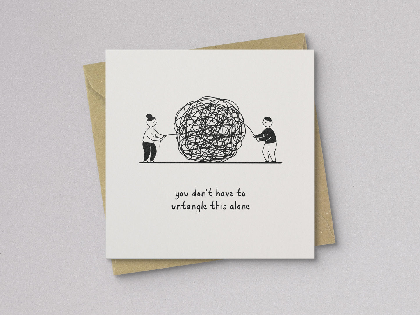 Sympathy card with illustration of two people pulling a tangled ball of string and text "you don't have to untangle this alone