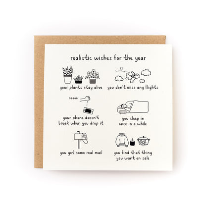 Realistic Wishes for the Year Letterpress Card with whimsical handwritten wishes and illustrations on white cardstock with kraft envelope.