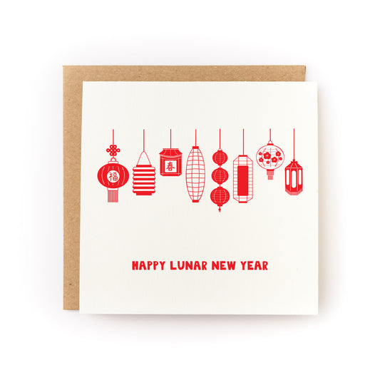 White greeting card featuring a row of red, hand-drawn Asian-style lanterns hanging in various shapes with "Happy Lunar New Year" text below, paired with a brown kraft envelope.