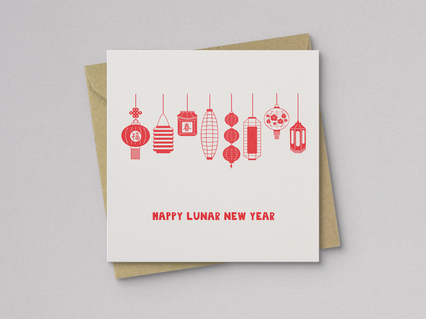 Square greeting card with a simple design of eight red, hand-drawn Asian lanterns hanging in a row above the text "Happy Lunar New Year," paired with a brown kraft envelope.