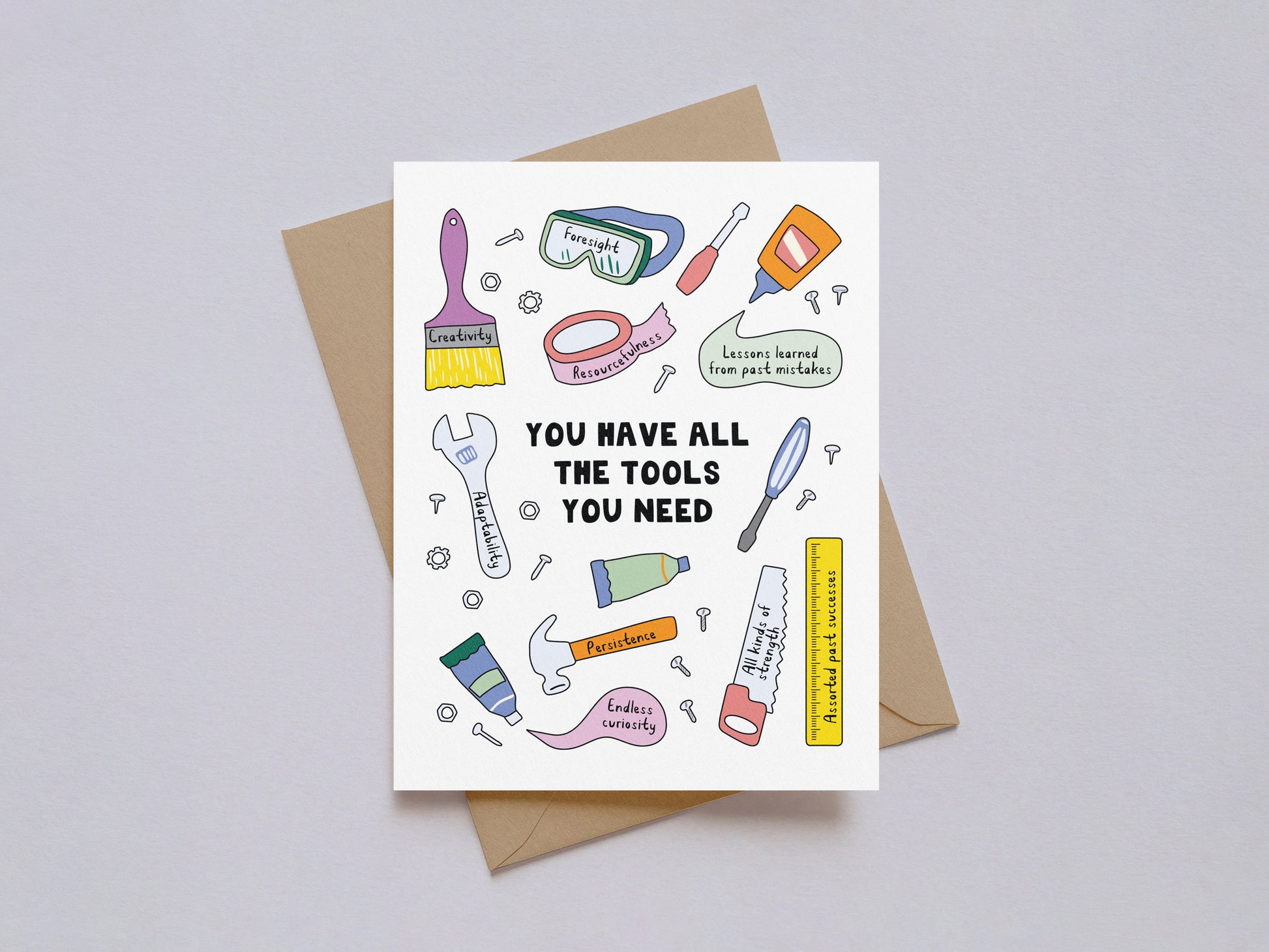 Encouragement card with illustrated tools and motivational phrases on white background with kraft envelope behind