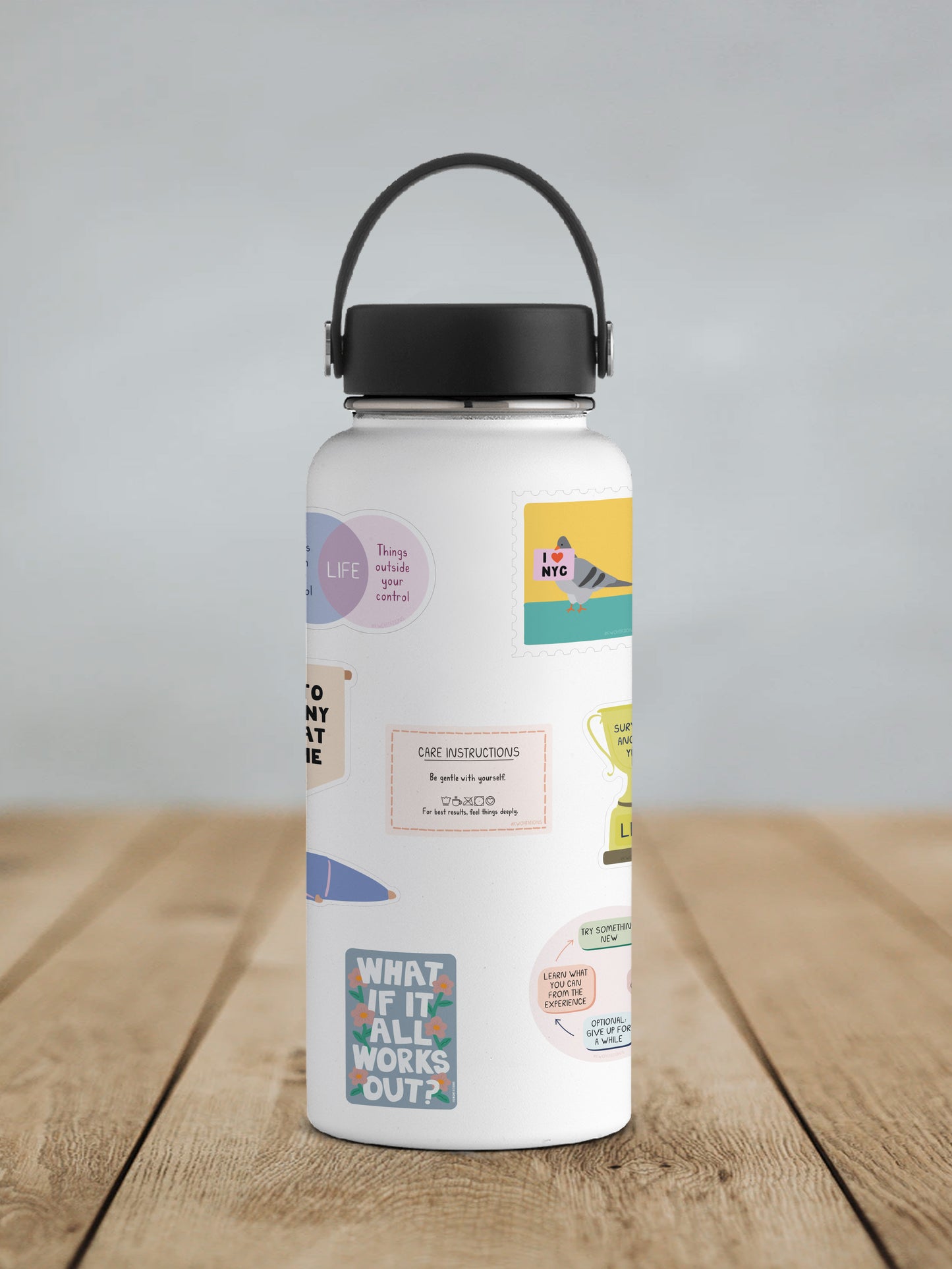 White water bottle with colorful matte vinyl stickers featuring inspirational messages and playful illustrations.
