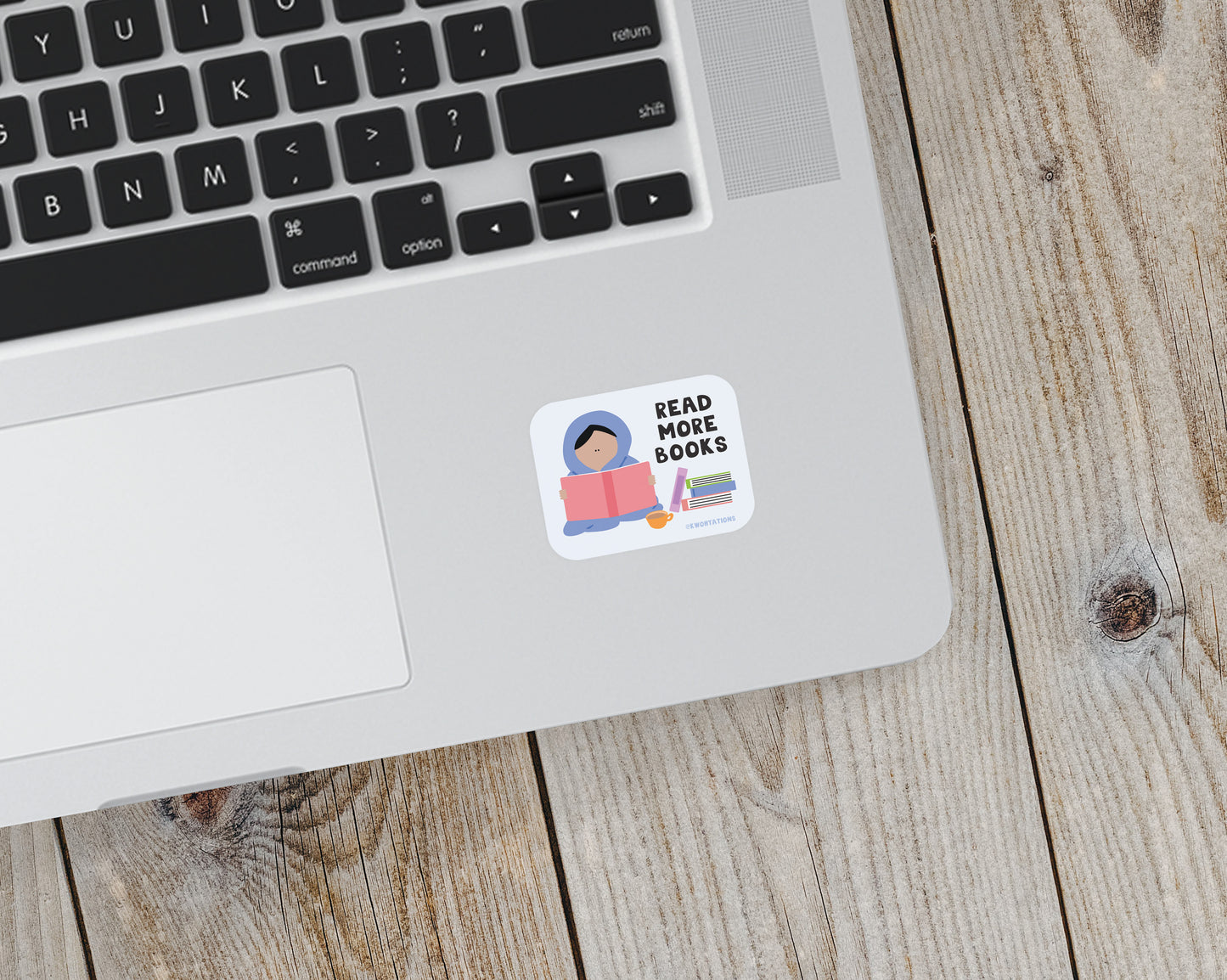 Matte vinyl sticker on laptop showing illustrated person reading a book with text "Read More Books" and stacked books.