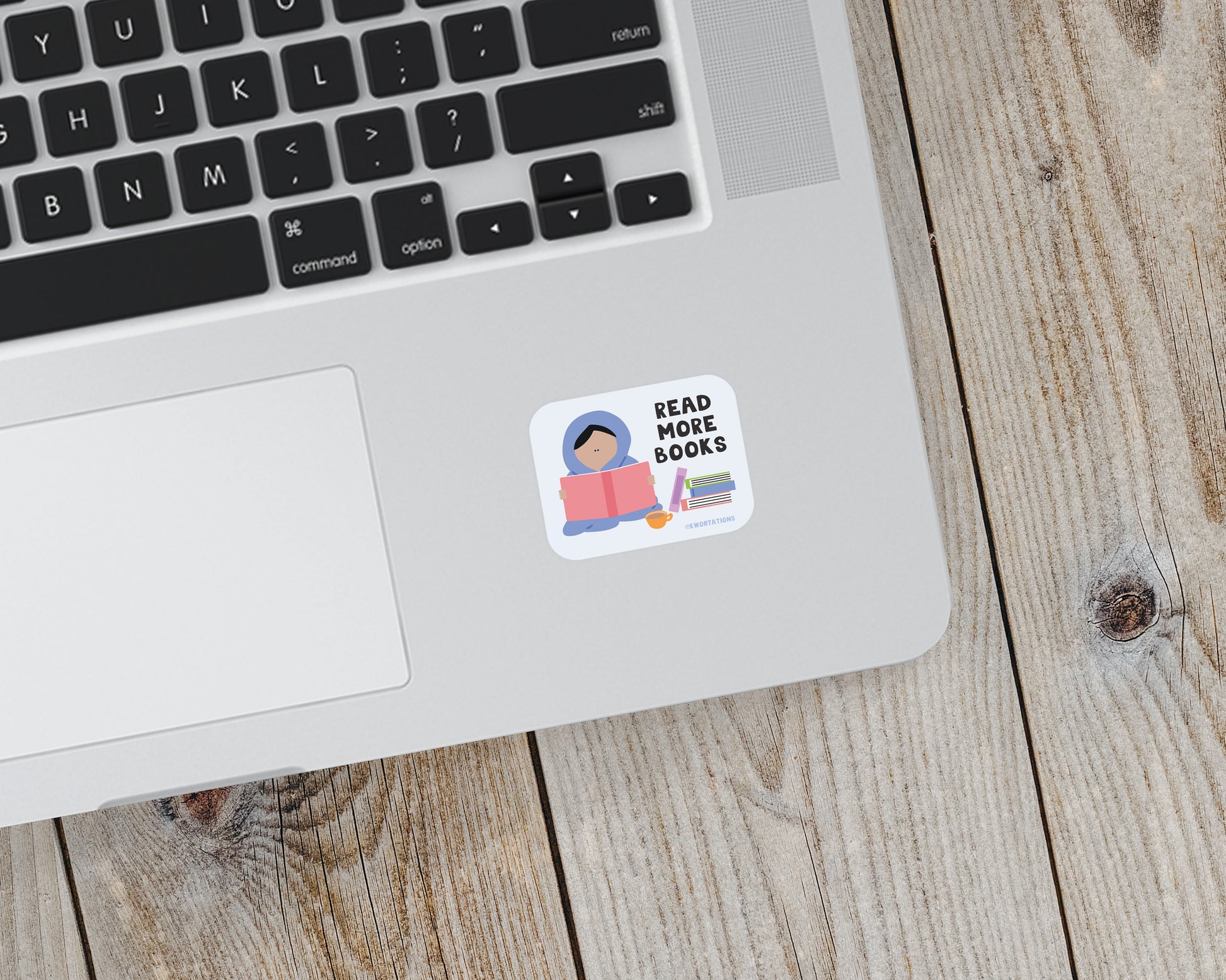 Matte vinyl sticker on laptop showing illustrated person reading a book with text "Read More Books" and stacked books.