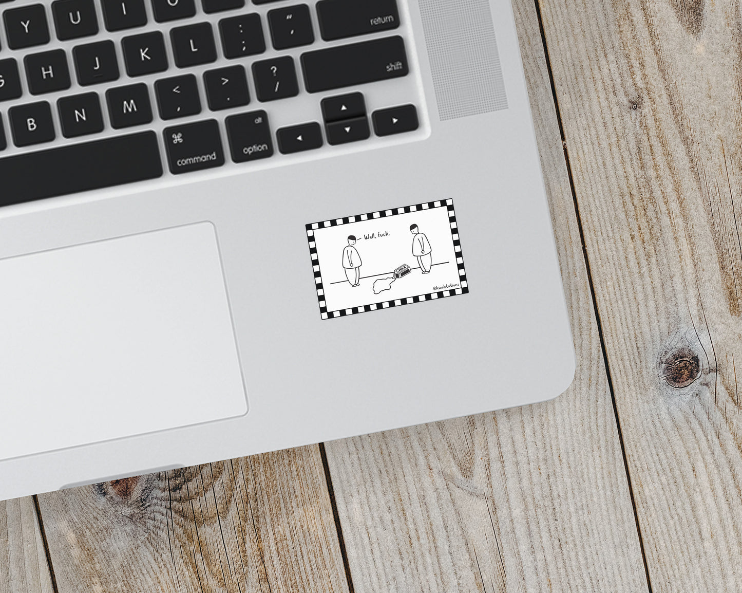 Black and white cartoon sticker on a laptop showing two simple figures standing near a spilled milk carton, one commenting with the text "Well, fuck," framed by a checkered border.