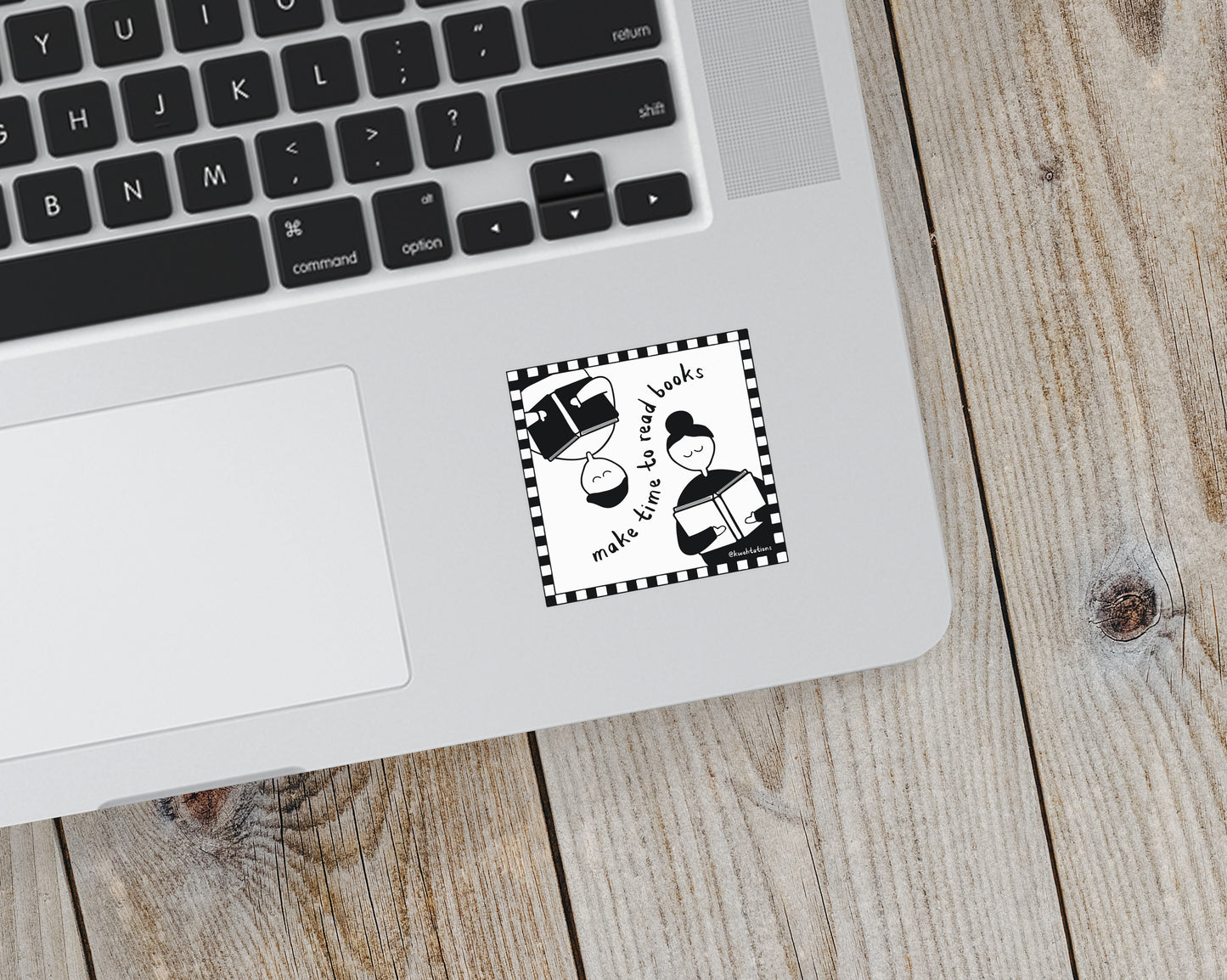 Black and white sticker on a laptop showing two simplified figures reading books, arranged opposite each other with the phrase "make time to read books" inside a checkered border.