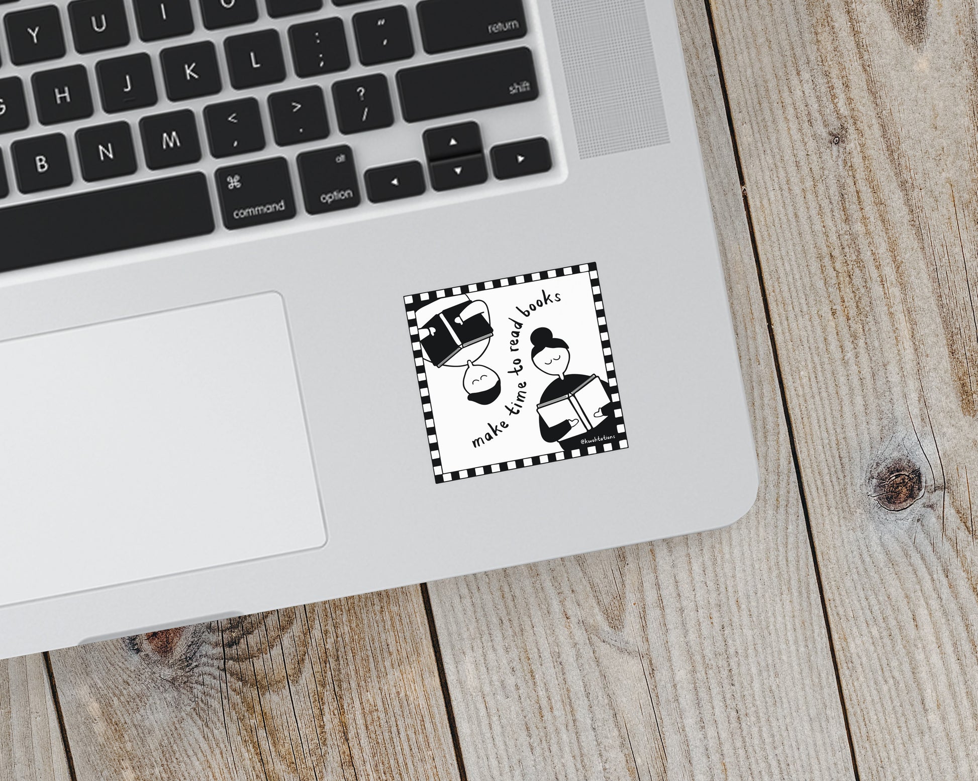 Black and white sticker on a laptop showing two simplified figures reading books, arranged opposite each other with the phrase "make time to read books" inside a checkered border.