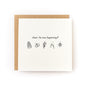 Folded wedding card with black illustrations of cake, rings, flowers, clinking glasses, and disco ball on white background