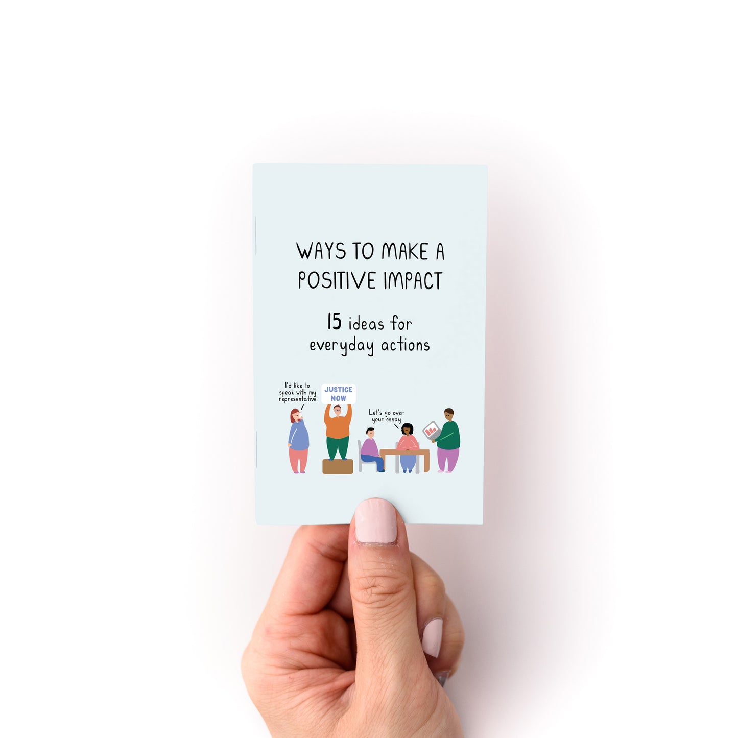 Hand holding a small booklet titled Ways to Make a Positive Impact with 15 ideas and diverse illustrated characters on cover.